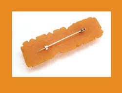 Carved Apricot Bakelite Pin Back